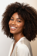 Light-skinned Black woman with voluminous hair