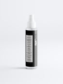 White spray bottle with a black label on a white background