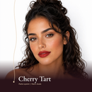 Model wearing Matte Lipstick in Cherry Tart, a deep cherry red.