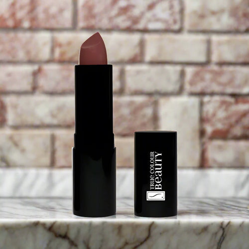 Melrose Charm lipstick displayed elegantly on a marble countertop with soft lighting to highlight its rosy charm