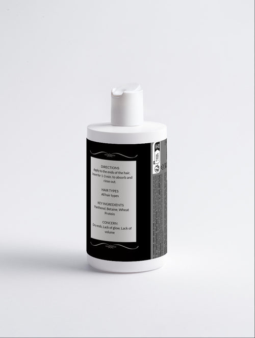 White bottle with a black label on a light gray background