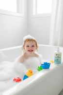 Redhead girl covered in bubbles