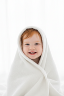 Redhead girl fully wrapped in towel