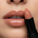 Close-up of a person applying nude lipstick to their lips with a focus on the product.