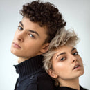 man and woman back to back wearing black.