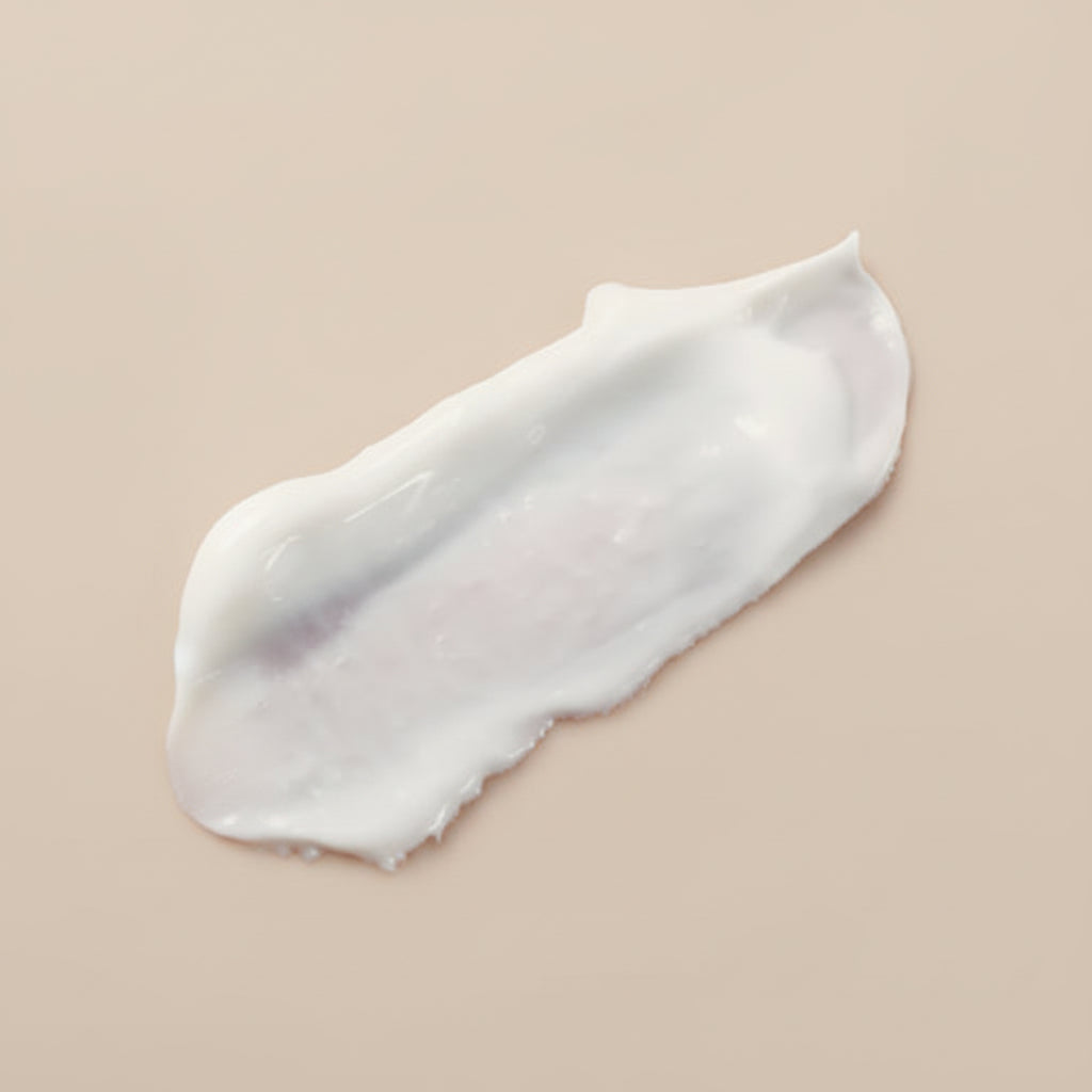 Close-up of a white cream being applied to skin